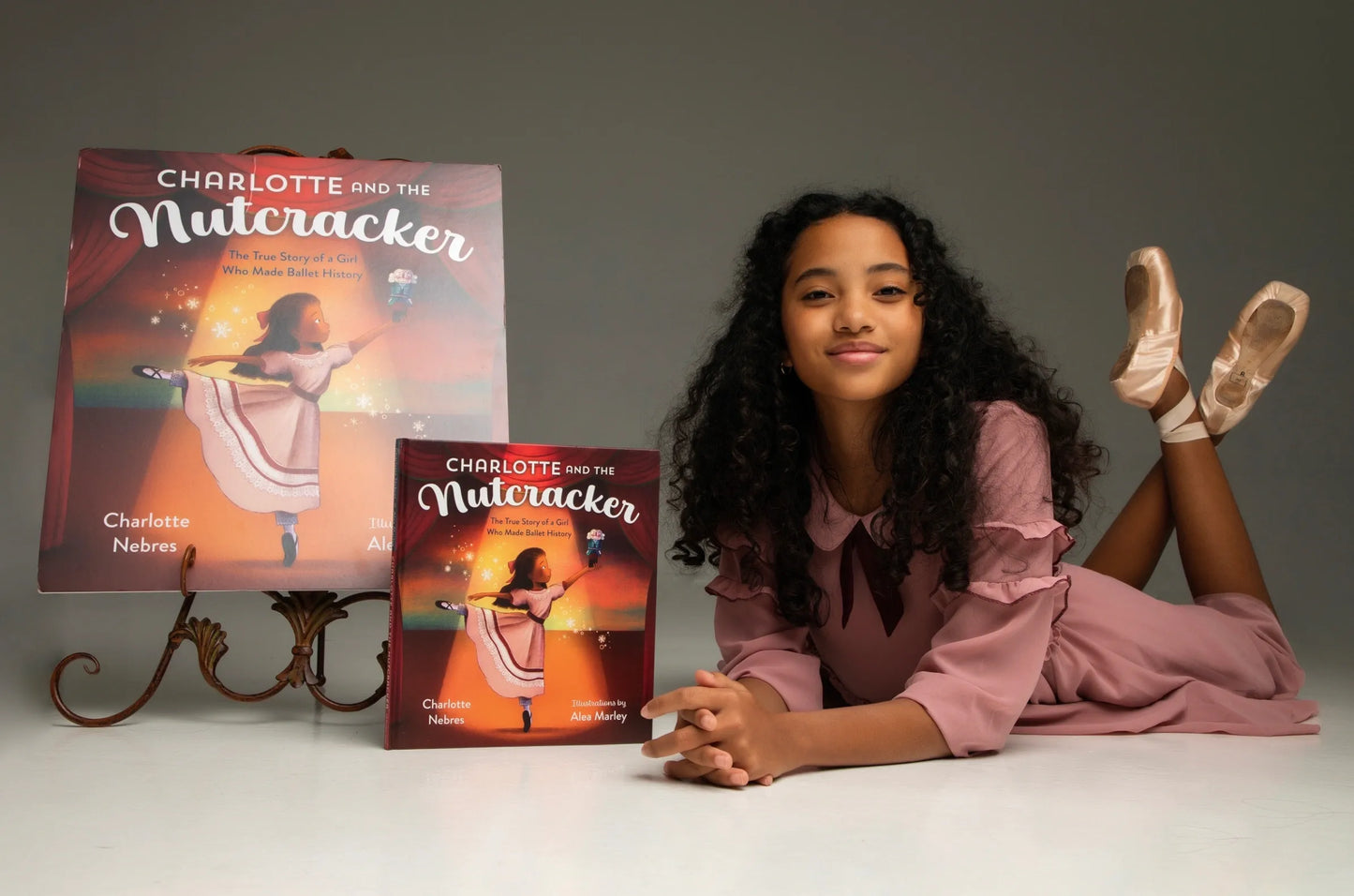 The author of Charlotte and the Nutcracker: The True Story of a Girl Who Made Ballet History, Charlotte Nebres, with two copies of her book.